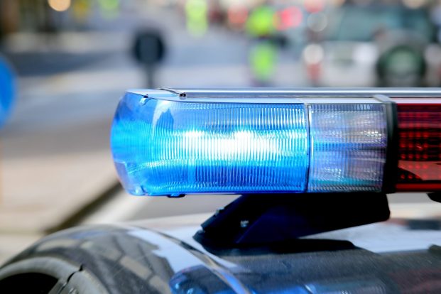 blue flashing police car during a roadblock to hunt down the escaped prisoners
